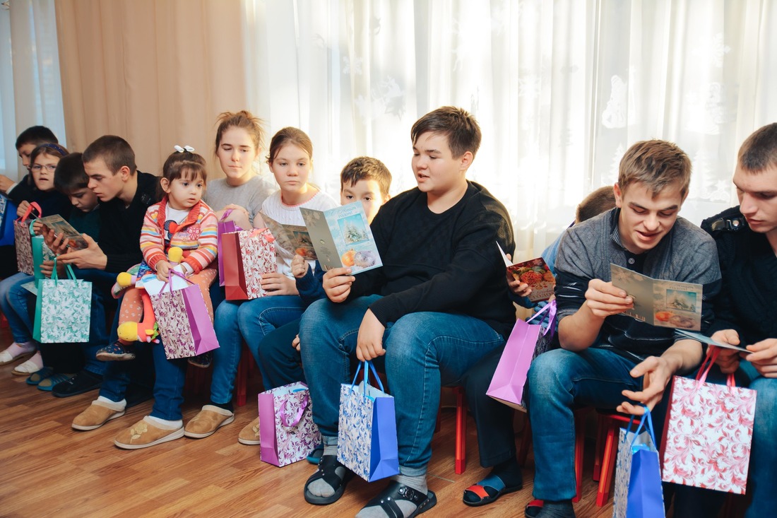 Дети читают новогодние открытки сверстников